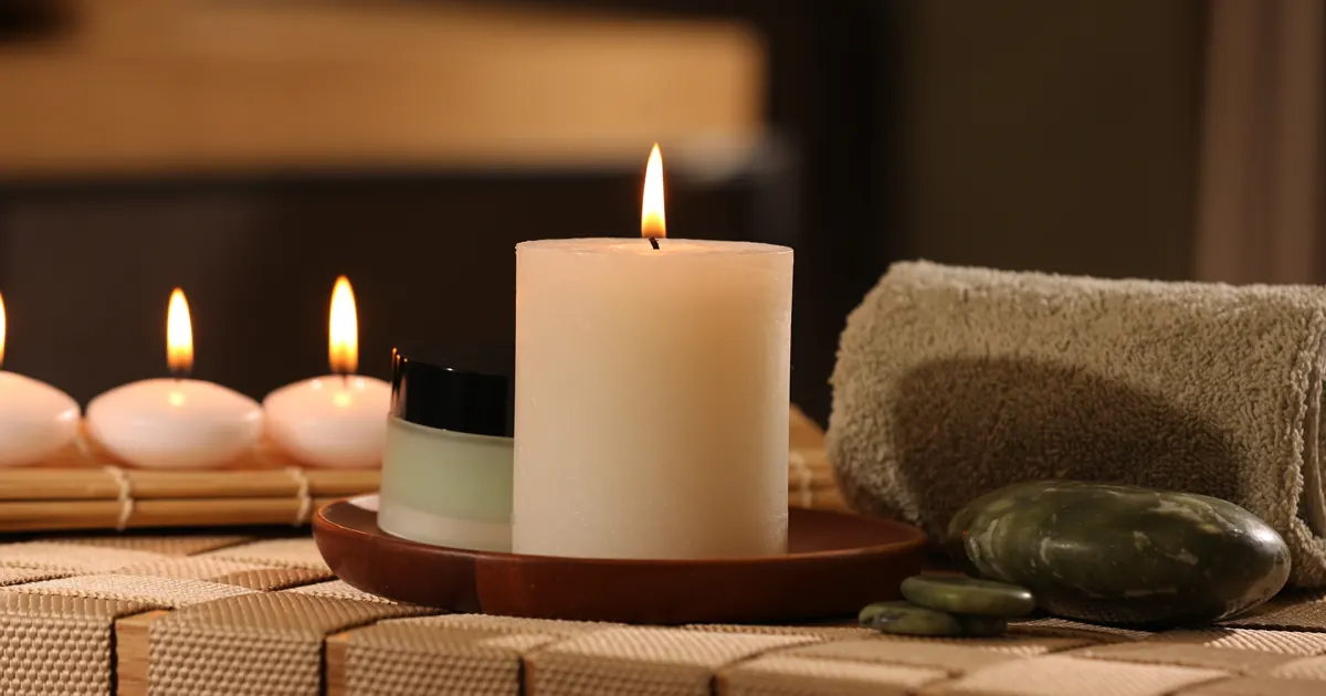 Safe Homeopathic Remedies for Cold and Flu Symptoms Lit candles and spa stones creating a calm resting space