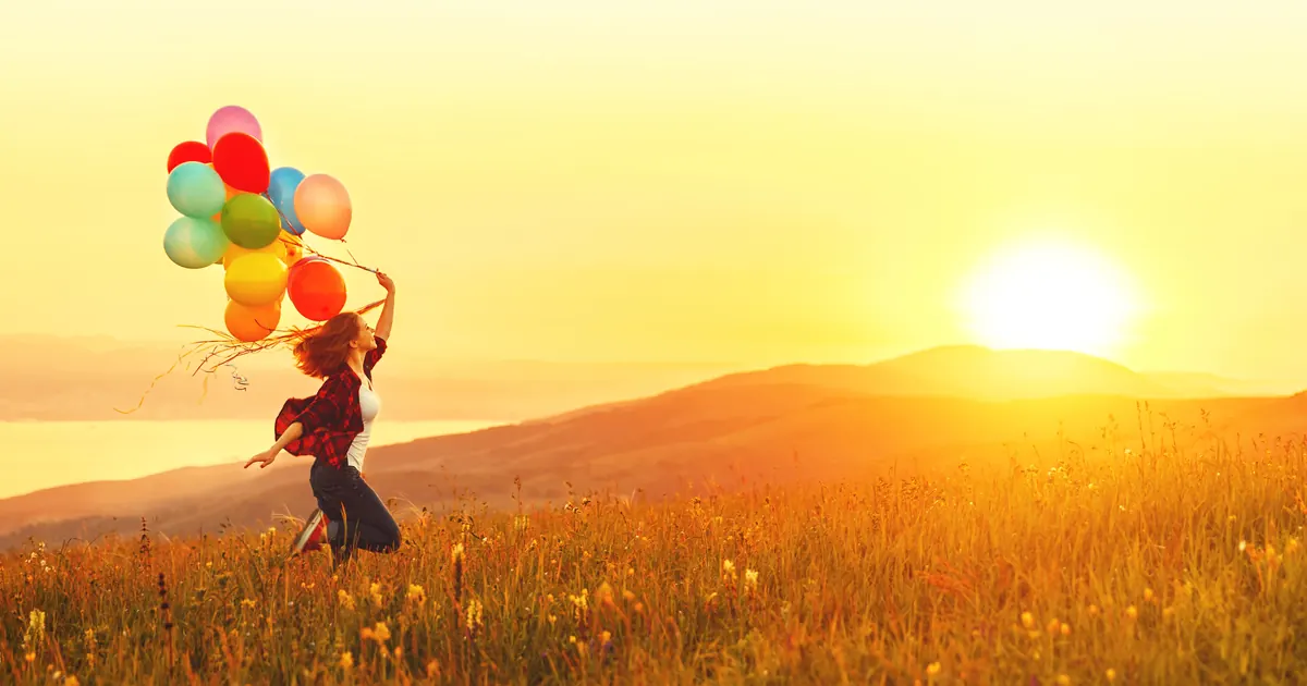 Natural Allergy Relief: Homeopathy for Hay Fever Woman running through a meadow with colorful balloons at sunset