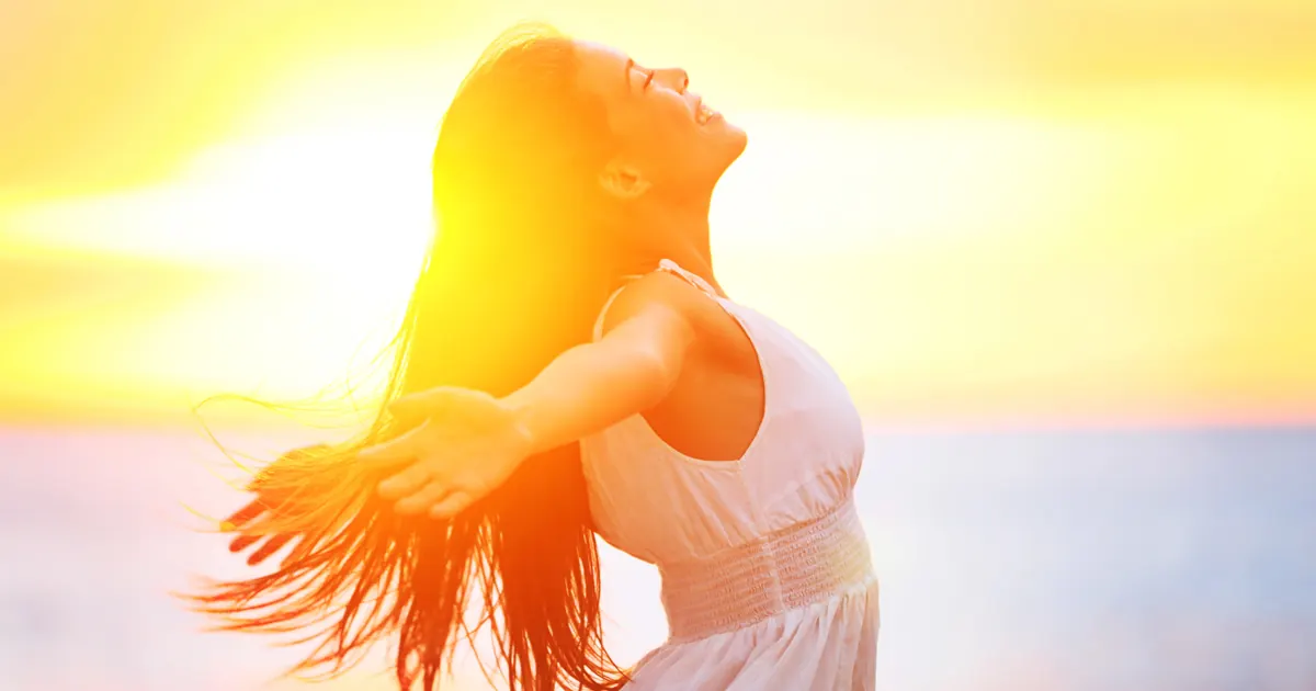 Homeopathy for Joint Pain: Natural Alternatives That Help Woman with arms open, enjoying the sun by the sea
